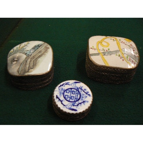 260 - THREE 20TH CENTURY ORIENTAL SILVER METAL TRINKET BOXES, THE TOPS WITH PORCELAIN INSERTS.