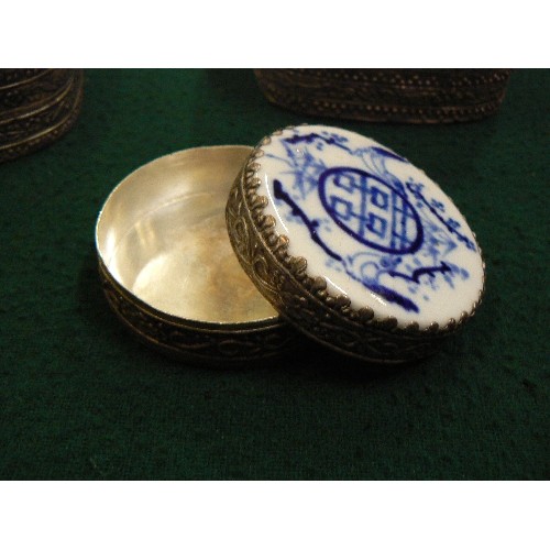 260 - THREE 20TH CENTURY ORIENTAL SILVER METAL TRINKET BOXES, THE TOPS WITH PORCELAIN INSERTS.