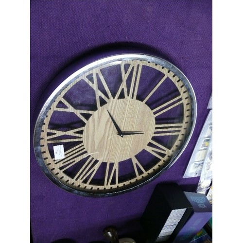 356 - LARGE CONTEMPORARY WALL CLOCK, STAINLESS STEEL BORDER AND FAUX WOOD FRETWORK CENTRE.