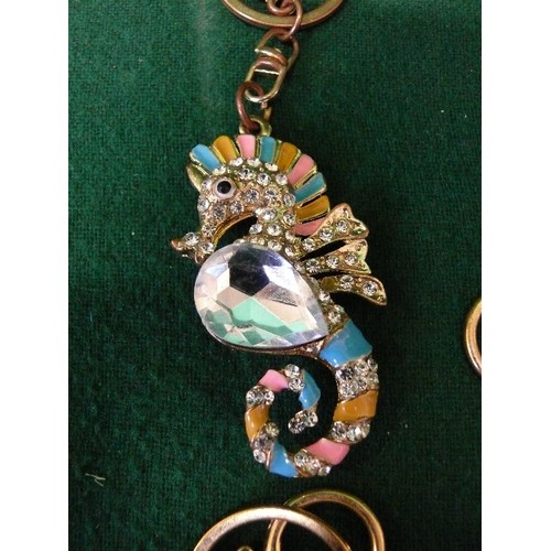 57 - FOUR KEYRINGS ENCRUSTED WITH BLING -  DOG, UNICORN, SEAHORSE AND AN ELEPHANT.