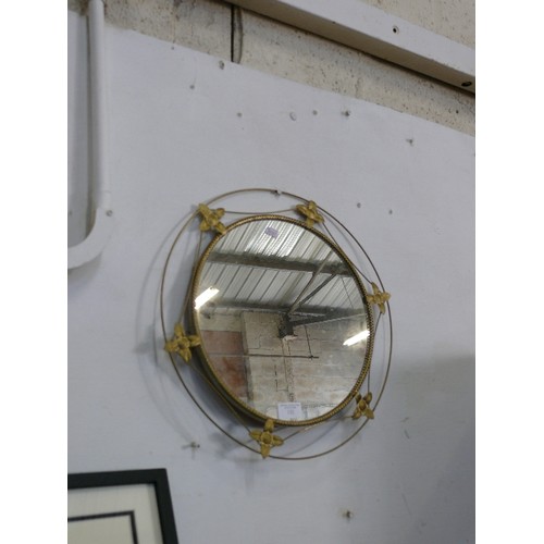 132 - A CIRCULAR DECORATIVE BRASS FRAMED MIRROR.