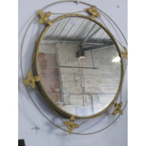 132 - A CIRCULAR DECORATIVE BRASS FRAMED MIRROR.