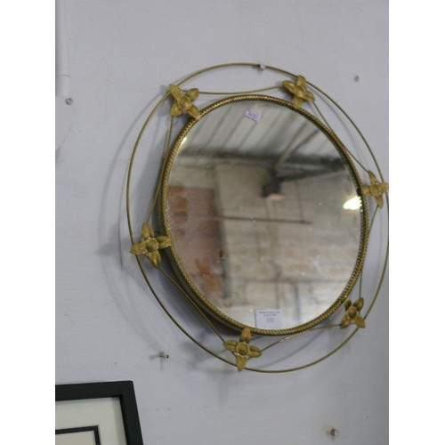 132 - A CIRCULAR DECORATIVE BRASS FRAMED MIRROR.