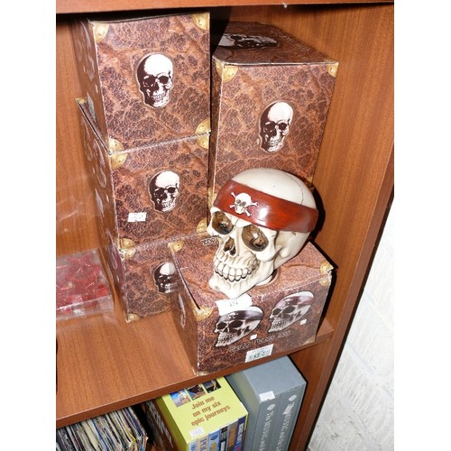 151 - SIX SKULL MONEY BOXES IN THREE DIFFERENT STYLES.