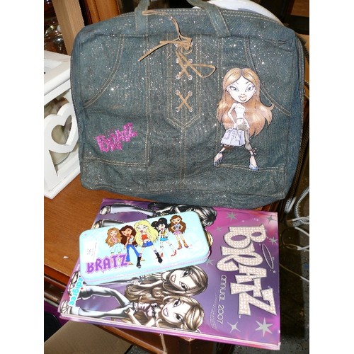 279 - A BRATZ BACKPACK WITH CONTENTS OF DOLL AND CLOTHING PLUS A PENCIL TIN AND BOOK.