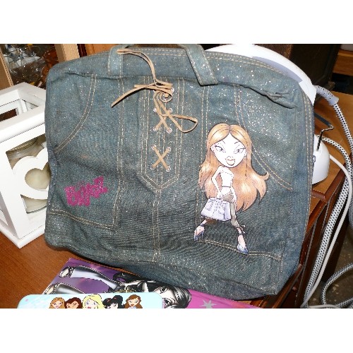 279 - A BRATZ BACKPACK WITH CONTENTS OF DOLL AND CLOTHING PLUS A PENCIL TIN AND BOOK.