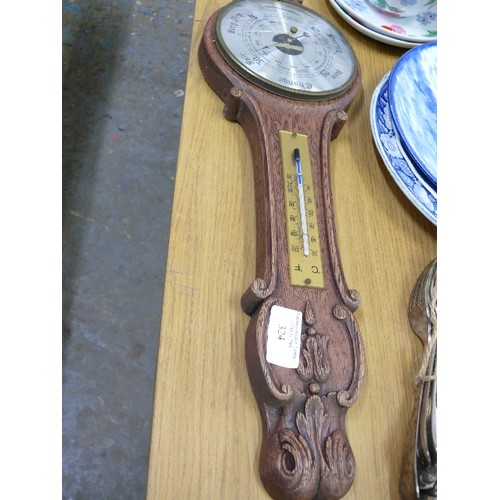 324 - A VINTAGE CARVED OAK WALL BAROMETER.