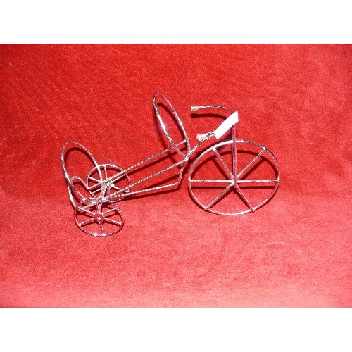 135 - A WINE BOTTLE HOLDER IN THE SHAPE OF A TRICYCLE.