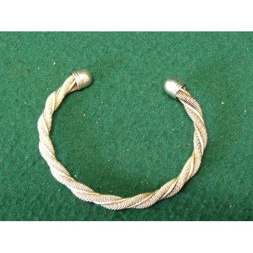 24 - A SILVER BANGLE MARKED 925.