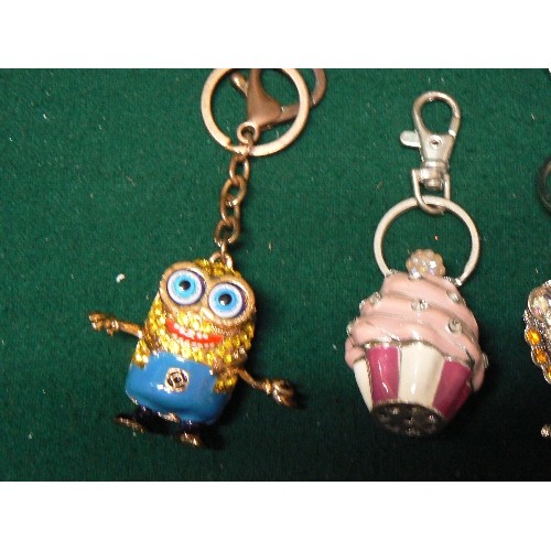 46 - FOUR NOVELTY KEY RINGS ENCRUSTED IN BLINGY STONES -  CAMERA, LION, CUP CAKE, PLUS ONE OTHER.