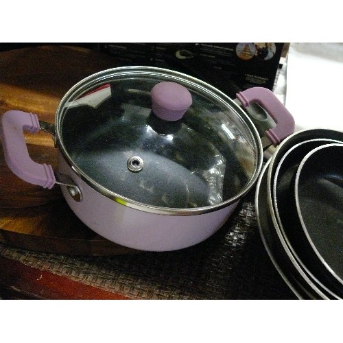 311 - A SMALL PINK SAUCEPAN AND MATCHING COLANDER PLUS THREE SMALL FRYING PANS.