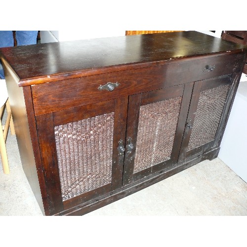 406 - DARK WOOD SIDEBOARD WITH THREE  CUPBOARDS WITH RATTAN PANELS.