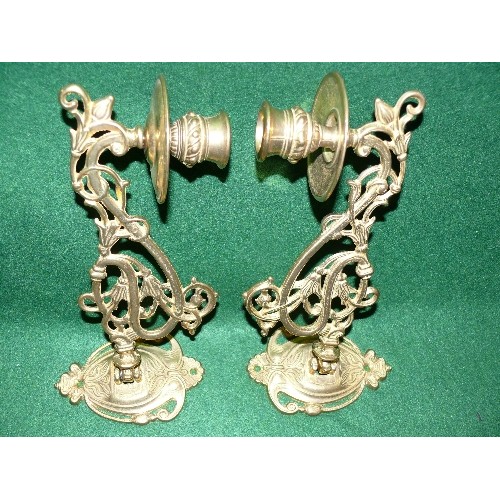 195 - A PAIR OF BRASS PIANO SCONCE CANDLE HOLDERS.