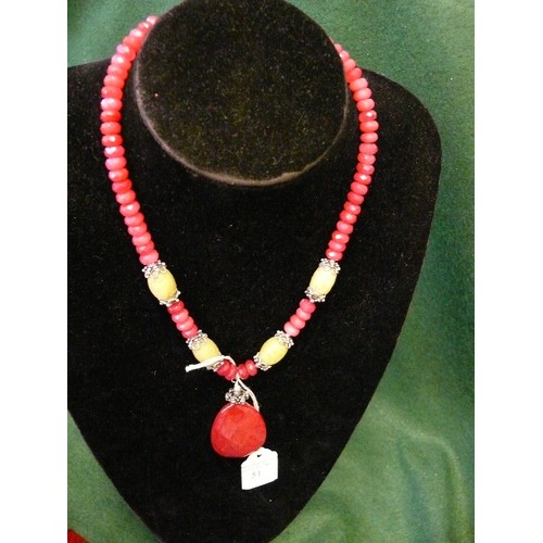 52 - TWO NECKLACES.  A VERY UNUSUAL STONE NECKLACE WITH SILVER FITTINGS AND A 'TEBETAN' STYLE RED AND GRE... 