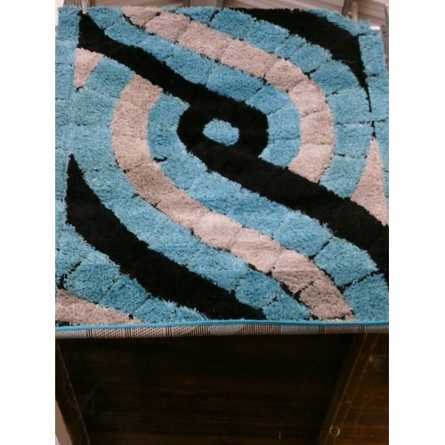 401 - GREY AND BLACK ON BLUE CONTEMPORARY RUG APPROX 3' X 4'.