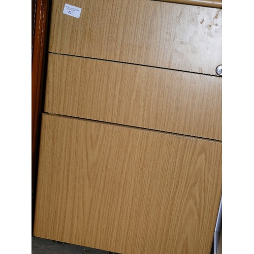 421 - THREE DRAWER FILING CABINET IN LIGHT WOOD EFFECT.