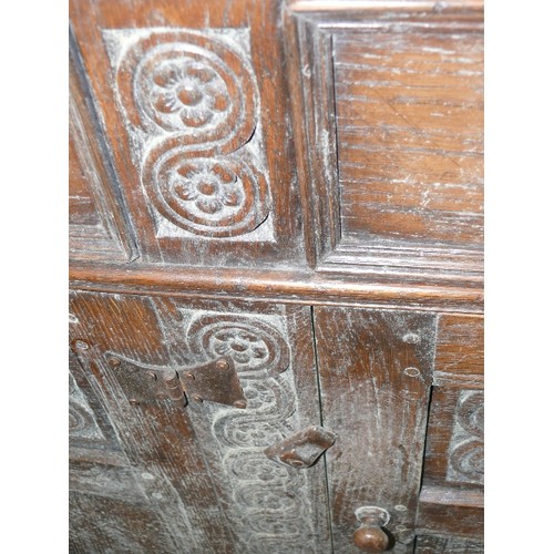 424 - SOLID OAK, CARVED SIDEBOARD WITH THREE DRAWERS AND THREE CUPBOARDS.