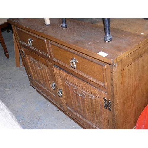 446 - SOLID OAK CARVED DRESS BASE, TWO DRAWERS AND TWO CUPBOARDS.