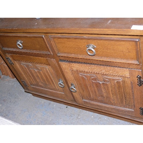 446 - SOLID OAK CARVED DRESS BASE, TWO DRAWERS AND TWO CUPBOARDS.