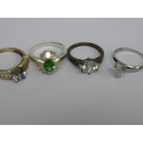 40D - FOUR SILVER METAL DRESS RINGS.