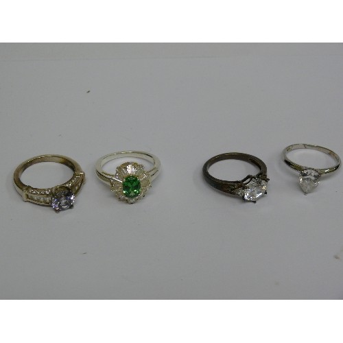 40D - FOUR SILVER METAL DRESS RINGS.