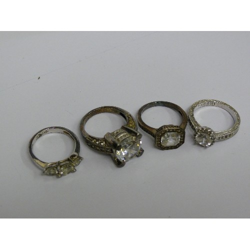 40E - FOUR SILVER METAL DRESS RINGS.