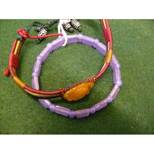 30 - TWO BRACELETS, ONE HAND CARVED PURPLE JADE WITH THE SIGNS OF CHINESE YEARS. THE OTHER A TIBETAN GOOD... 