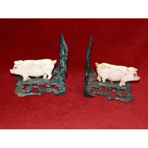 63 - A PAIR OF CAST METAL PIG BOOKENDS.