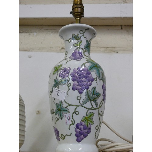 89 - A CERAMIC TABLE LAMP WITH GRAPE DECORATION.