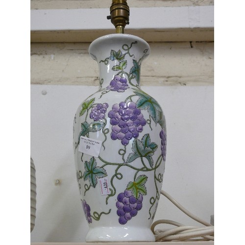 89 - A CERAMIC TABLE LAMP WITH GRAPE DECORATION.