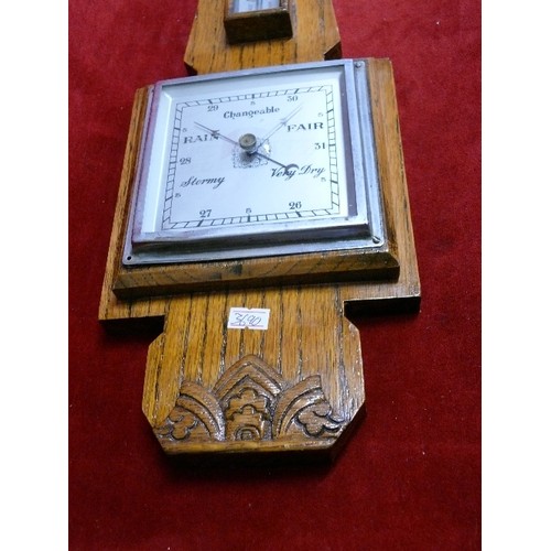 115 - A DECORATIVE WOODEN BAROMETER.