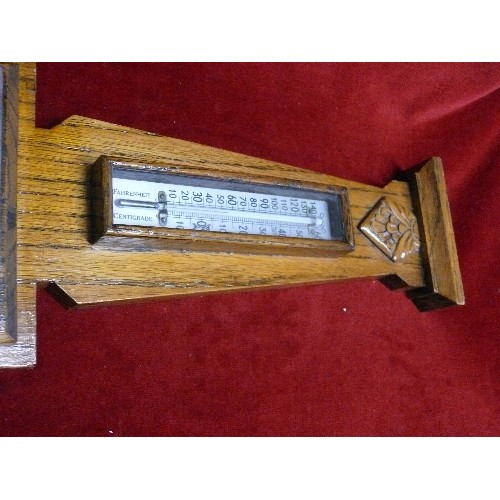 115 - A DECORATIVE WOODEN BAROMETER.