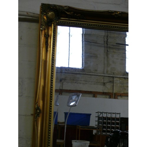 235 - LARGE BEVEL EDGED ORNATE GILT FRAMED WALL MIRROR.