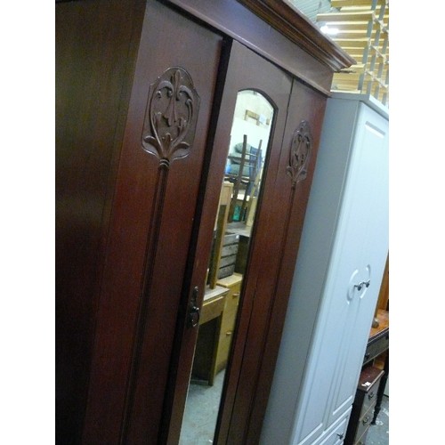 418 - WARDROBE WITH BEVEL EDGED CENTRAL MIRROR AND CARVED ART NOUVEAU MOTIF TO OUTER PANELS, DRAWER UNDERN... 