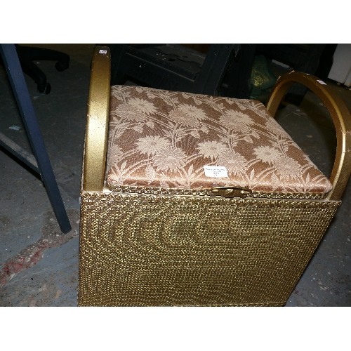 373 - A WOVEN STORAGE STOOL WITH A PADDED SEAT.