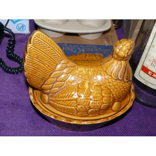 210 - A STONEWARE MUFFIN TRAY BY THE PAMPERED CHEF, CHICKEN EGG CROCK AND A LARGE BELLS WHISKY BOTTLE.