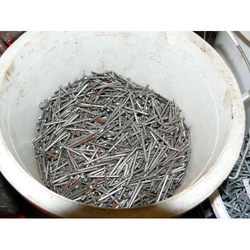 239 - FOUR TUBS OF NAILS INCLUDING ONE TUB OF GALVANISED NAILS.