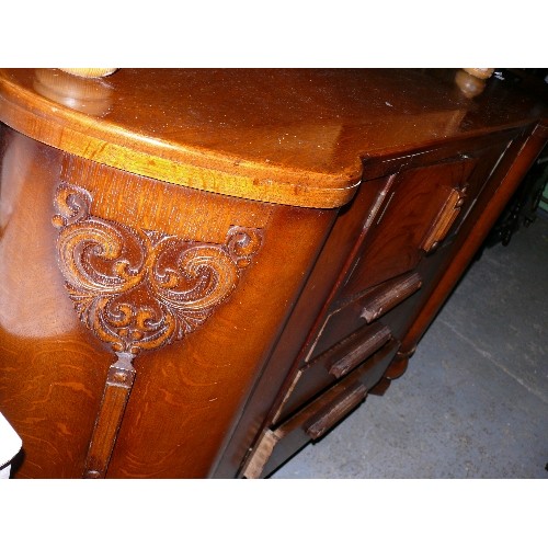 387 - A LARGE WOODEN SIDEBOARD.