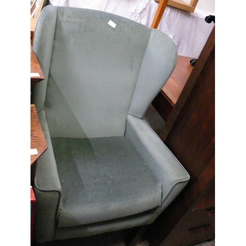 404 - A GREEN WING BACKED ARMCHAIR.
