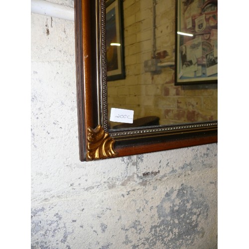 200C - GILT FRAMED MIRROR WITH ART NOUVEAU STYLE CORNERS.