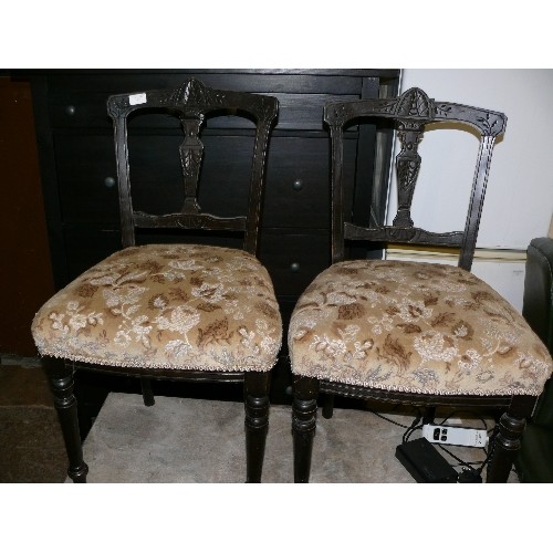 463 - THREE CARVED EDWARDIAN EBONISED CHAIRS WITH UPHOLSTERED SEATS.