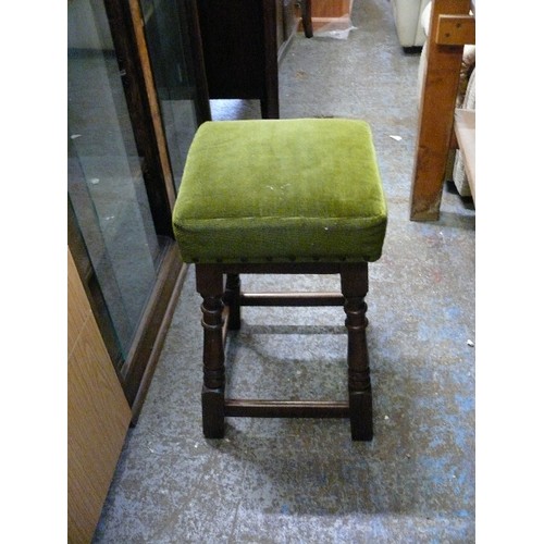 399 - A GREEN UPHOLSTERED TOPPED STOOL.