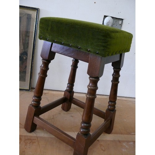 399 - A GREEN UPHOLSTERED TOPPED STOOL.