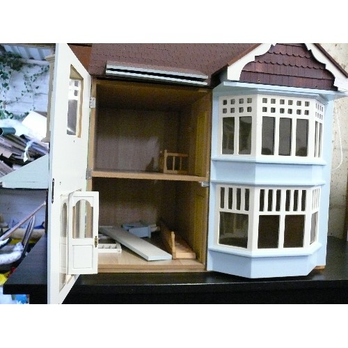 416 - A LARGE WOODEN DOLLS HOUSE WITH BAY WINDOWS.