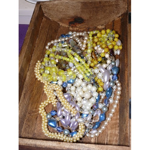 69 - WOODEN CHEST WITH CONTENTS OF A LARGE QUANTITY OF COSTUME JEWELLERY.