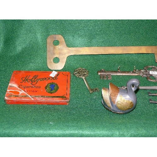 73 - A SELECTION OF KEYS, PENDULUM CIGARETTE TIN AND A PEWTER SWAN.