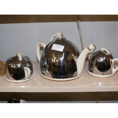 324 - A VINTAGE CELTIC BEEHIVE TEASET IN CERAMIC AND CHROME.