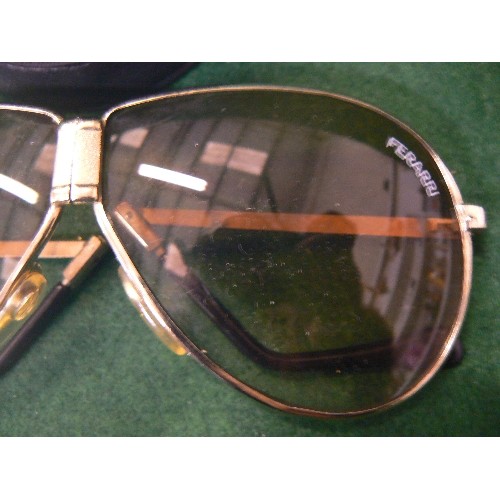 83 - A PAIR OF FOLDABLE FERRARI SUNGLASSES IN ORIGINAL CASE (scratches on one lens).