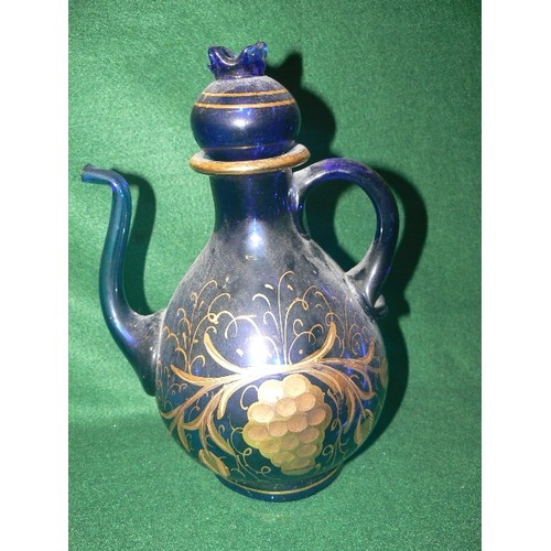 76 - A DECORATIVE HEAVY BLUE GLASS TEAPOT WITH GOLD DETAIL.