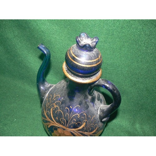 76 - A DECORATIVE HEAVY BLUE GLASS TEAPOT WITH GOLD DETAIL.